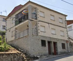 Un edificio con un balcón en el lateral. en Casa Rural, “El Andador”, en El Hoyo de Pinares