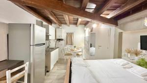 a kitchen and a bedroom with a bed in a room at Porta Rossa - Boutique Home in Florence in Florence +13 photos