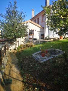 a backyard of a house with a fountain in the yard at Casal de Perros 