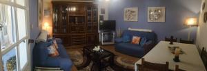 a living room with a blue couch and a table at Casal de Perros 