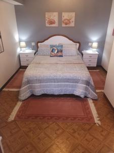 a bedroom with a large bed with two night stands at Casal de Perros 