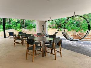 a dining room with a table and chairs and large mirrors at Luxury Studio-private individual pool-IIK C409 By Sandy Powerful in Tulum