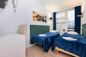 Posteľ alebo postele v izbe v ubytovaní UnitApartament Warszawa Centrum Room in Apartment by Metro Rondo ONZ Super wygodne noclegi zapraszamy