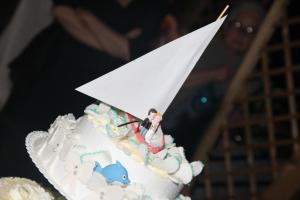 a cake with a paper sailboat on top of it at Forum Cassii in Vetralla