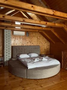 a large bed in a room with a wooden ceiling at Holiday Home Aladin's in Bihać