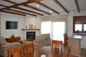 a living room with a couch and a table at Casa Rural La Madroña in Fuentelabrada de los Montes
