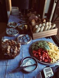 a table topped with lots of different types of food at AL "Villa Por Do Sol" Sunset Olhão in Olhão