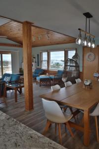 a living room with a table and chairs at Amazing Ocean View-Newly Renovated Modern Oasis in Avon