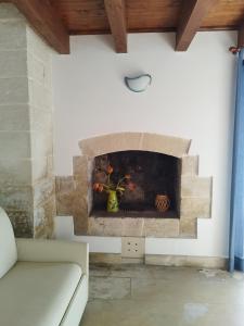 a living room with a stone fireplace at B&B Terra Serena in Santa Cesarea Terme
