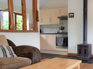 a living room with a couch and a stove at 2 Bed in Thetford 64075 in East Harling