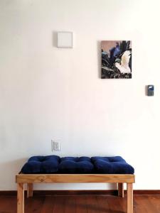 a blue couch in front of a white wall at Catherine Suites in Willemstad