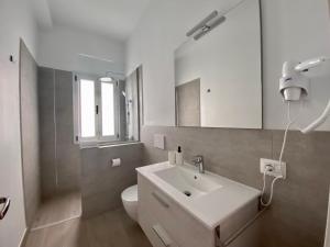 a white bathroom with a sink and a toilet at Casa Antonio - apartamento Orion in Playa de San Juan +29 photos