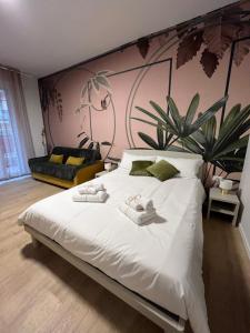 a bedroom with a large white bed with slippers on it at Calari Rooms - Monolocale in Bologna