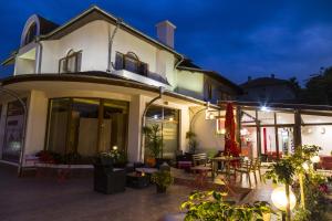 a building with a patio with tables and chairs at Hotel GabriSa in Razgrad