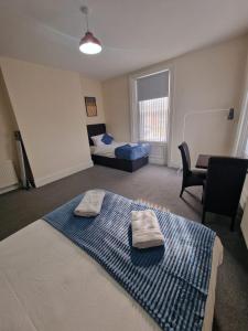 1 dormitorio con 1 cama con 2 toallas en LaLuNa One Bedroom Apartment Newcastle, en Elswick