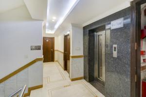 a corridor of a building with a hallway at Townhouse 517 La Sapphire Near Delhi Airport in New Delhi
