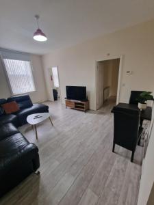 a living room with a couch and a table at LaLuNa One Bedroom Apartment Newcastle in Elswick