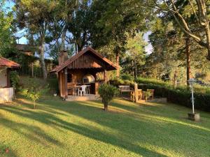 domek na dziedzińcu z trawnikiem w obiekcie Casa Aconchegante em Monte Verde w mieście Camanducaia