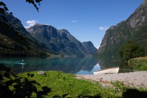 a person in a kayak on a lake in the mountains at Olden Glamping - One with nature in Stryn