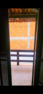 an open door to a room with a window at Casa simples de frente para praia 5km do centro in Saquarema