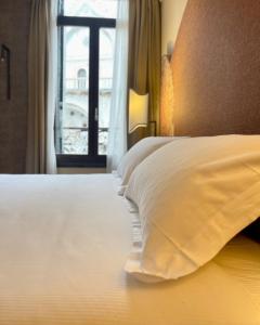 a bedroom with a white bed with a window at 286 Piazza San Marco in Venice