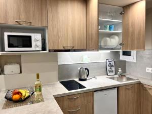 a kitchen with a sink and a microwave at Agorakritou Magic Corner in Athens