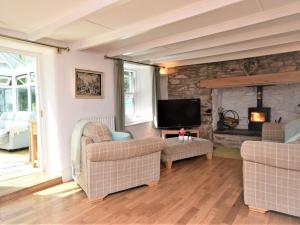 a living room with two chairs and a fireplace at 3 bed in Perranporth 57204 in Perranzabuloe