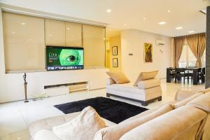 ein Wohnzimmer mit 2 Sofas und einem Flachbild-TV in der Unterkunft Impeccable 3-Bed luxury Apartment in ikoyi Lagos in Lagos