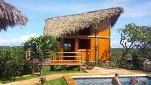 a house with a swimming pool in front of it at Ilha dos Poldros in Araioses