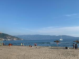 a group of people on a beach near the water at Arial Lofts in Vlorë