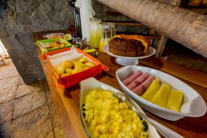 a table topped with plates of food on a table at Ilha dos Poldros in Araioses