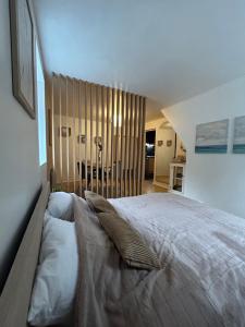 a bedroom with a large bed with pillows on it at Dieppe F2 pour 4 personnes emplacement idéal 2 min à pied de la plage et des boutiques in Dieppe