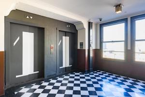 a hallway with a checkered floor in a building at STILE Downtown Los Angeles by Kasa in Los Angeles