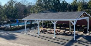 a pavilion with picnic tables and benches in a park at Baymont by Wyndham Dublin in Dublin