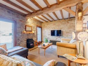 a living room with a stone wall at 2 bed in Brecon 80519 in Llangorse