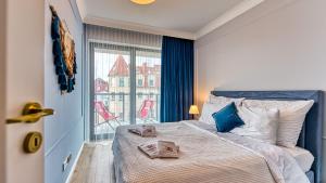 Postel nebo postele na pokoji v ubytování Rezydencja Niechorze 304 przy Plaży - 5D Apartamenty