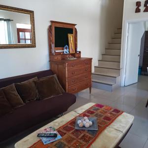 a living room with a couch and a dresser and stairs at Casa dos dormitorios in Iquique