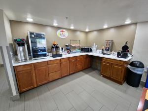 a coffee shop with a counter with a coffee maker at Super 8 by Wyndham Wickenburg AZ in Wickenburg