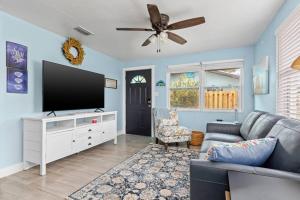 a living room with a couch and a flat screen tv at Downtown Punta Gorda 3 bd Bungalow in Punta Gorda
