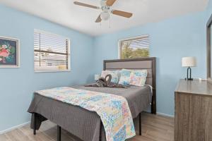 a bedroom with a bed with a ceiling fan at Downtown Punta Gorda 3 bd Bungalow in Punta Gorda