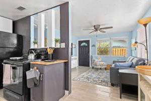 a kitchen with a stove and a living room at Downtown Punta Gorda 3 bd Bungalow in Punta Gorda