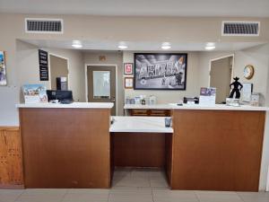 a lobby with two reception desks in a hospital at Super 8 by Wyndham Wickenburg AZ in Wickenburg