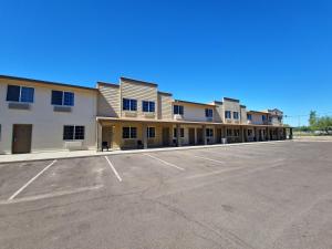 an empty parking lot in front of a building at Super 8 by Wyndham Wickenburg AZ in Wickenburg