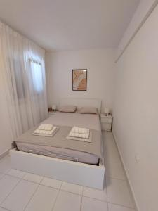 Postel nebo postele na pokoji v ubytování Apartments KUS Ugljan
