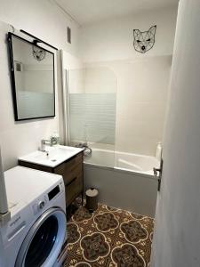 een badkamer met een wastafel en een wasmachine bij T3 Appart Cosy avec Terrasse proche Loire in Orléans