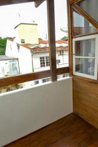 an open window with a view of a building at Verde Vida Ecopousada - Termas do Gravatal in Gravatal