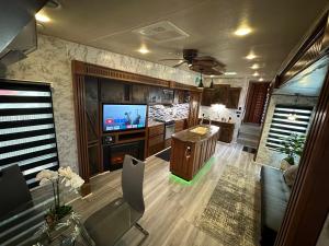 a living room with a television and a kitchen at Green world zone in Calusa in Key Largo