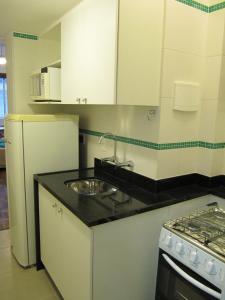 a kitchen with a sink and a stove at Alex Rio Flats Studio Beach View in Rio de Janeiro