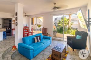 a living room with a blue couch and chairs at Antigua de Cabo in Cabo San Lucas