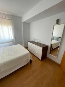 a bedroom with a bed and a large mirror at Apartamento SALITRE in Fuengirola